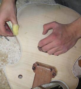 Sanding the binding flush with the body