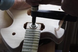 Clamping the set-in guitar neck in place