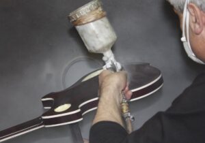 Spraying the back of the guitar body