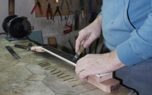 Filing the fingerboard fret slots